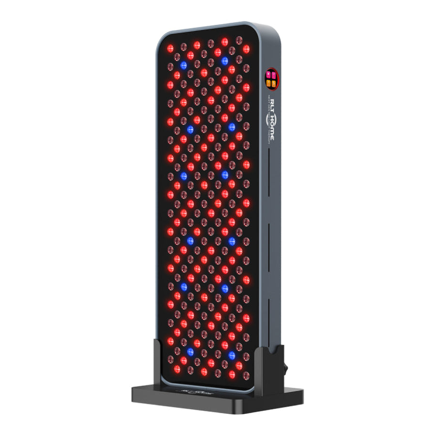 RLT Home Total Spectrum COMPACT red light therapy panel, front view with LEDs on, on its floor stand